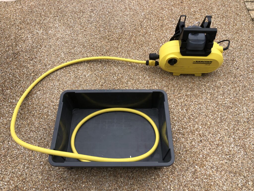 put-the-hose-from-the-high-pressure-washer-into-the-container-box
