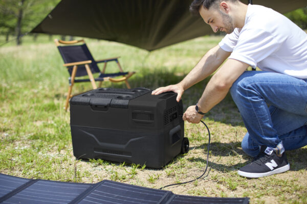 Man-Charging-Portable-Refrigerator-with-Solar-Panel