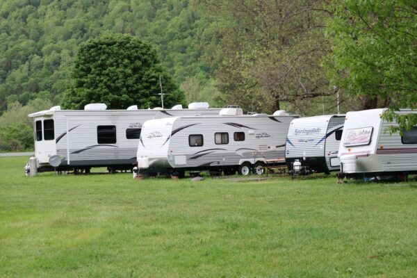 a-few-campers-parked-at-a-campsite
