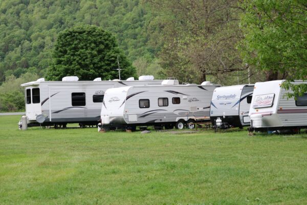 a-few-campers-parked-at-a-campsite
